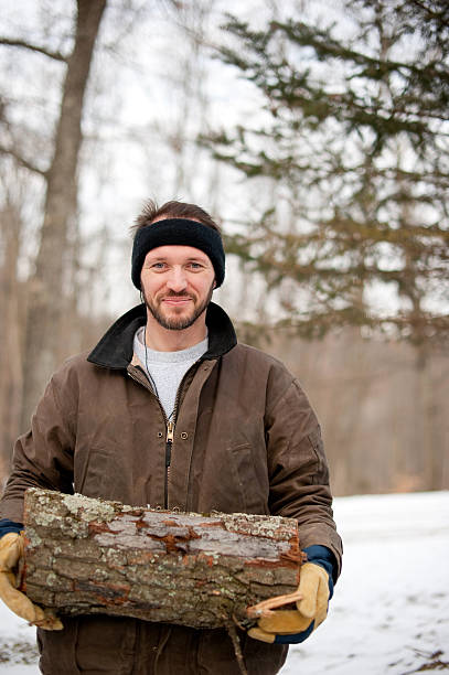 istock Man in winter with chopped wood 183342395
