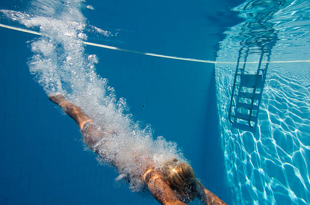istock Young women dives into the pool 183342924