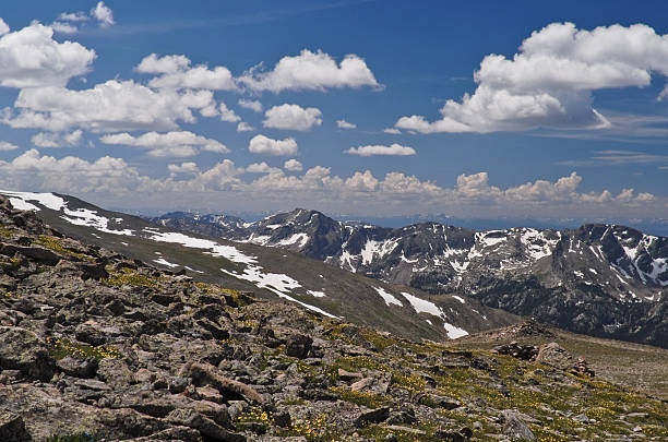 Gathering Clouds Over the Never Summer Range In the Colorado Rockies the typical mid-summer weather pattern is clear skies in the morning with gathering clouds by noon and afternoon thunderstorms. This picture of gathering clouds over the Never Summer Range was taken from Hallett Peak in Rocky Mountain National Park near Estes Park, Colorado, USA. jeff goulden rocky mountain national park stock pictures, royalty-free photos & images