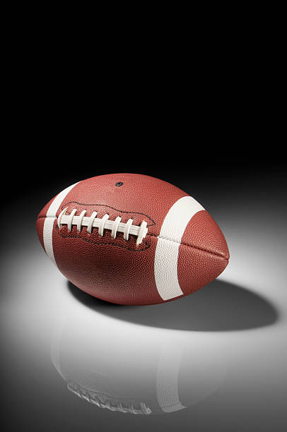 istock American football in spotlight on white background 183344165