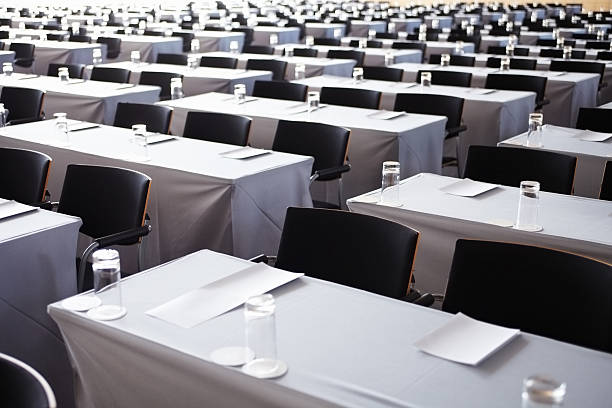 istock Large conference room filled with white tables 183344372