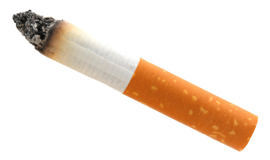 selective focus image of row of cigarettes against plain background