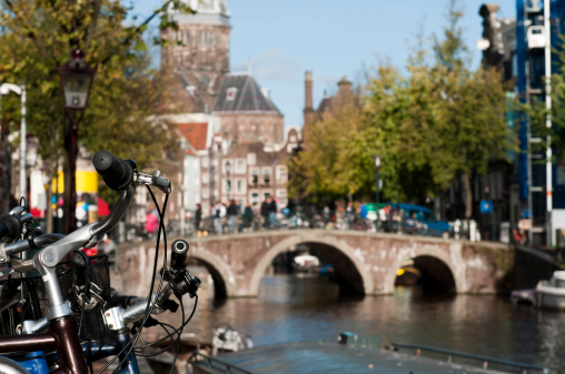 Amsterdam's view over canal. On the second plan Church of St. Nicolas. Focus on the bikes.Search: