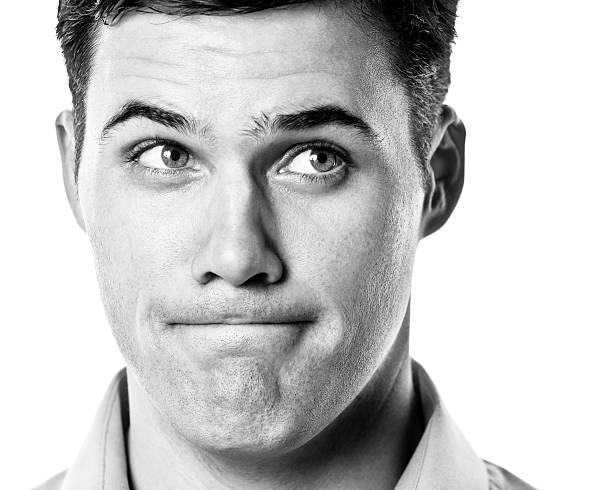 Portrait Of Shocked Man Covering Mouth At Home