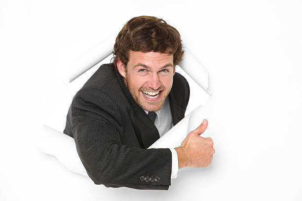 istock Businessman tearing through paper wall thumbs up 183345108