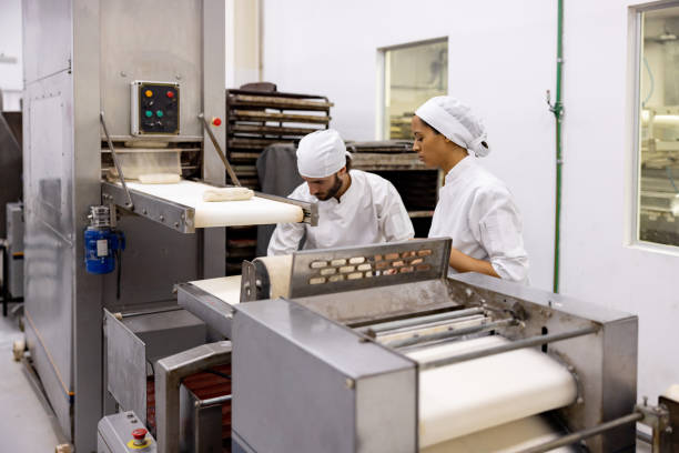 istock Team of bakers working at a food processing plant 1833455718