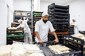 Worker getting packages ready for distribution at an industrial bakery