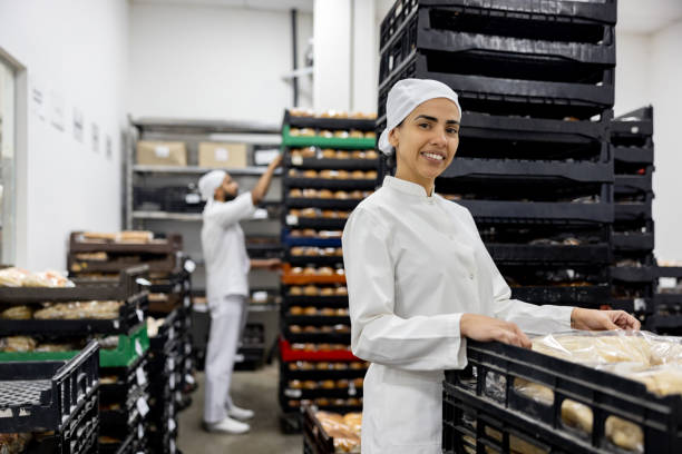 istock Woman working at food processing plant getting packages for transportation 1833456849