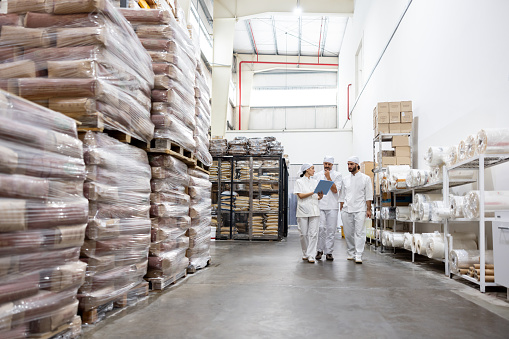 Team of employees talking at a food processing plant