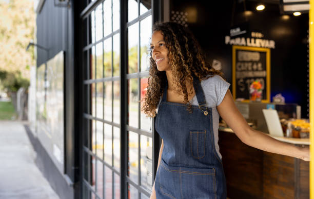 Waitress opening the door at a coffee shop