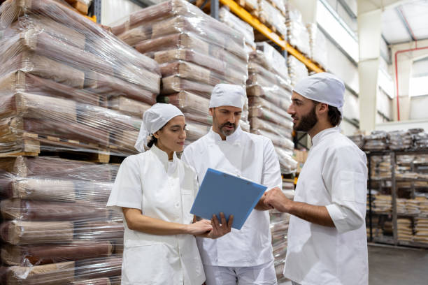 istock Team of workers talking in a meeting at a food processing plant 1833457363