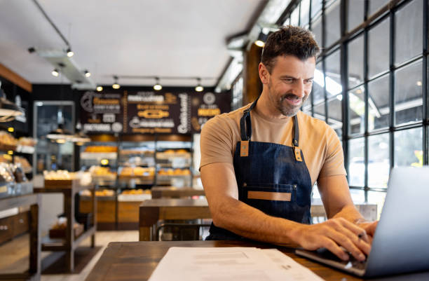 istock Business owner doing the accountancy while working at a coffee shop 1833457389