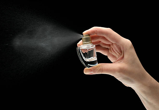 istock woman hand holding a perfume bottle 183345808