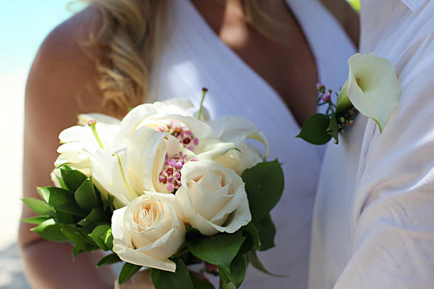 white carnation buttonhole on dark suit