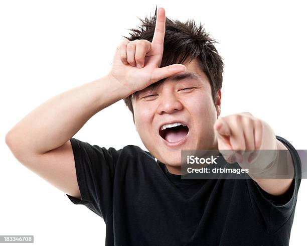 Young Man Gestures Loser L Hand Sign Laughs Points Stock Photo - Download Image Now