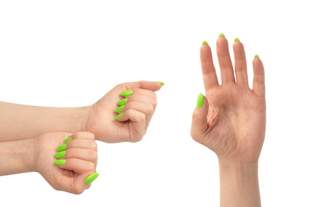 istock Hand of a woman with green naols hold some tiny or thin object. 1833467829
