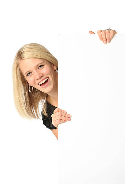 donna d'affari sorridente con dietro di manifesto - advertisement advertise businesswoman peeking foto e immagini stock