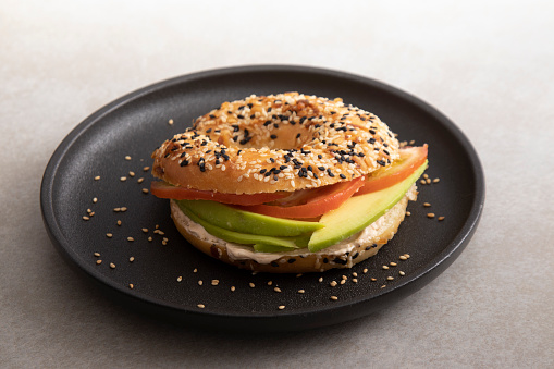 Poppy seed bagel with cream cheese and avocado healthy food