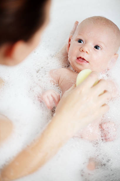 istock Newborn baby having a bath with mother 183347177