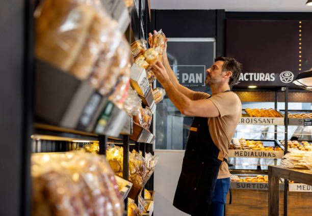 istock Retail clerk working at a bakery restocking the shelves 1833475929