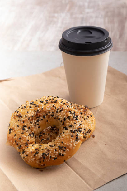 istock Poppy seed bagel served with coffee to go 1833475932