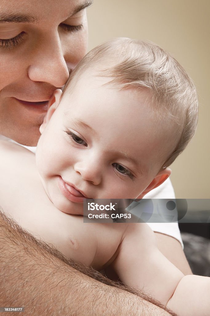 Father And Son Close up of a father holding his baby boy closely. 30-39 Years Stock Photo