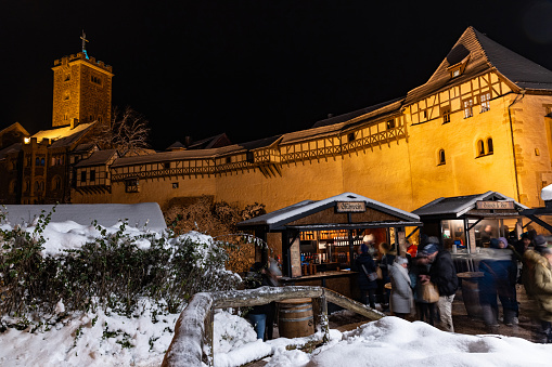 illuminated Wartburg castle near Eisenach with christmas market during advent time