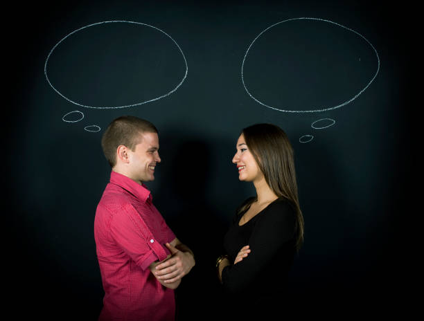 Happy Young Couple With Their Thought Bubbles