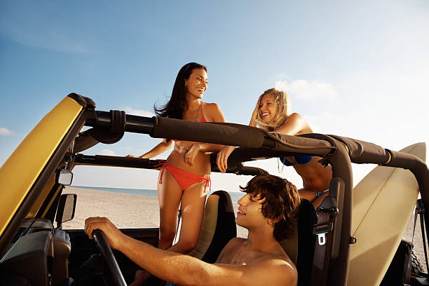 istock Young boy with friends in jeep enjoying their vacation 183348612