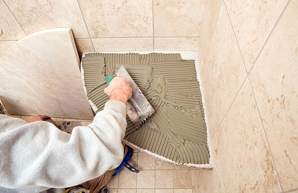 istock Tile Setter Applying Mortar with a Trowel to Shower Seat 183349443