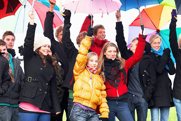 istock Smiling young teens holding umbrellas 183349566