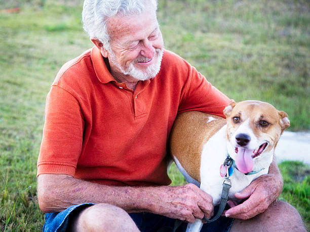 istock Handsome 79 year old Senior Man Petting His Dog 183349755