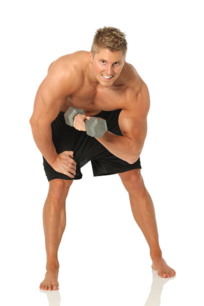 istock Isolated muscular man curling dumbbells 183349959