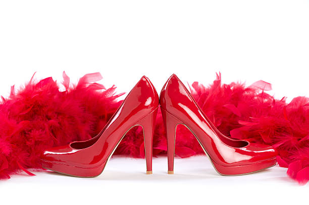 rot und sexy - feather boa feather isolated red stock-fotos und bilder