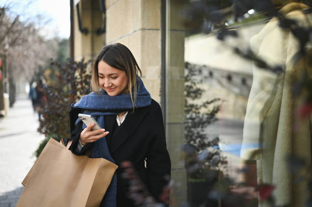 istock Shopaholic with bags using mobile phone. 1833503553