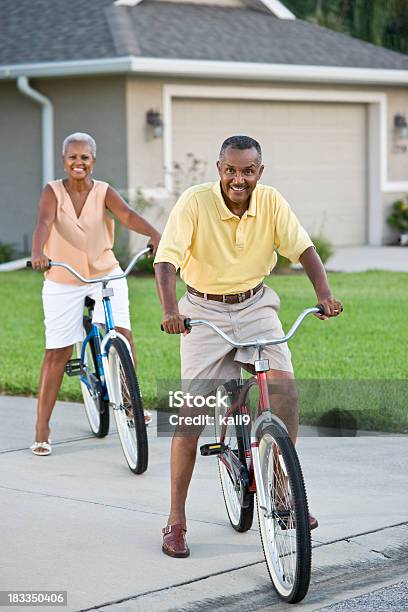 Senior African American Couple Riding Bicycles Focus On Man Stock Photo - Download Image Now