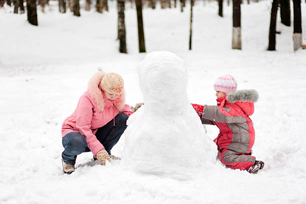 istock Mother and child making snowcat 183350627