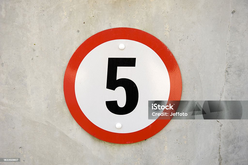 Five miles an hour road sign Warning sign for five miles an hour speed limit on a concrete wall Number 5 Stock Photo