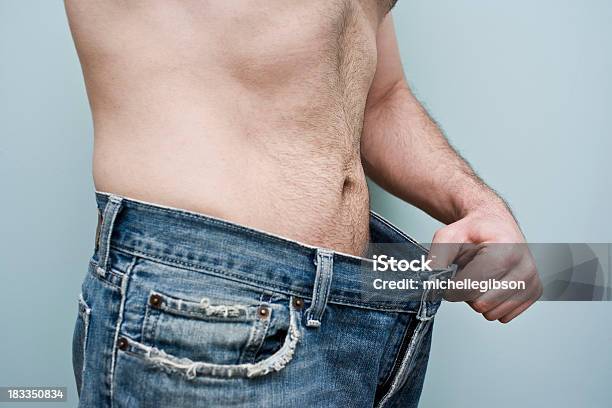 Man Showing Weight Loss By Showing His Loose Pants Stock Photo - Download Image Now - Men, Dieting, Only Men