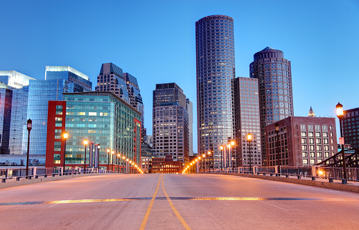 City street leading into downtown Boston at dusk. Boston is the largest city in New England, the capital of the state of Massachusetts. Boston is known for its central role in American history,world-class educational institutions, cultural facilities, and champion sports franchises.
