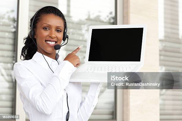 Operator Pointing At Computer Display Stock Photo - Download Image Now - Women, Administrator, African Ethnicity
