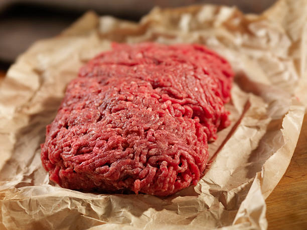 Minced Meat in Butcher Paper Minced Meat in Butcher Paper-Photographed on Hasselblad H3D2-39mb Camera GROUND BEEF stock pictures, royalty-free photos & images