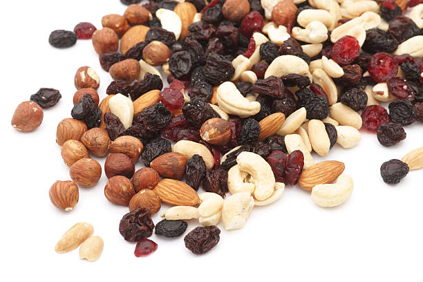 Mixed nuts and dry fruits over white background Mixed nuts and dry fruits over white background dried fruit on white stock pictures, royalty-free photos & images