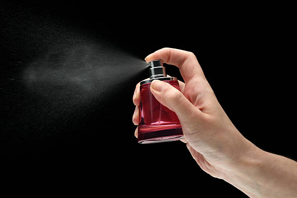 istock woman hand holding a perfume bottle 183352413