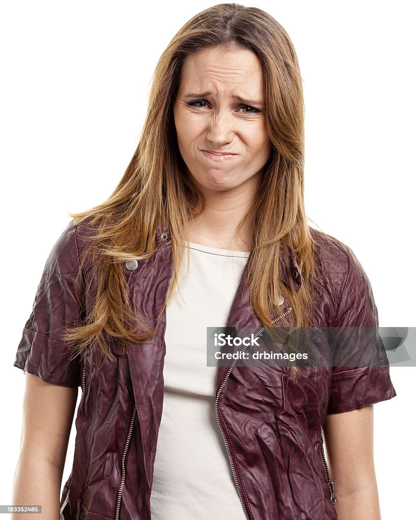 Disgusted Young Woman Grimacing Portrait of a young woman on a white background. Women Stock Photo