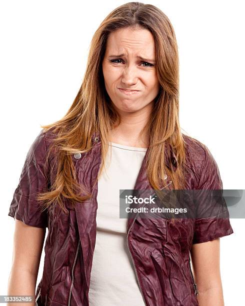 Disgusted Young Woman Grimacing Stock Photo - Download Image Now - Women, Biting Lip, Brown Hair