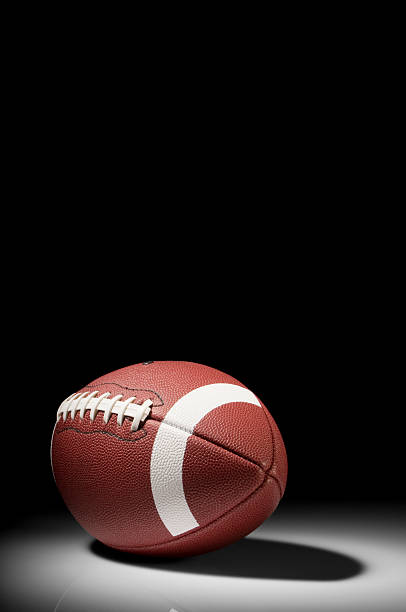 istock American football in spotlight on white background 183352628