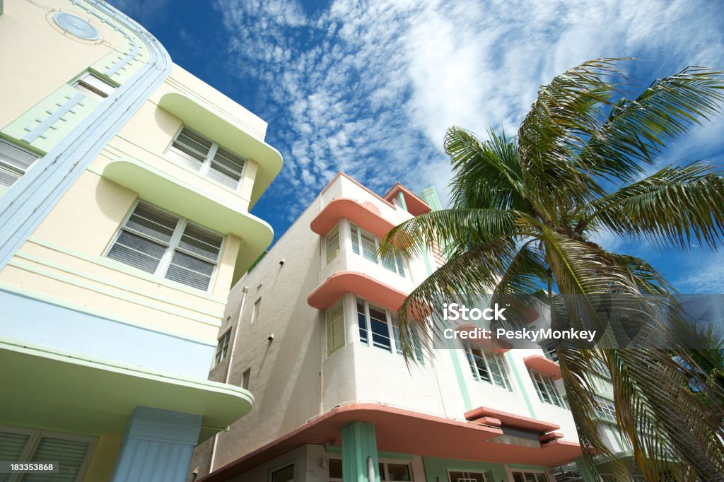 Miami Art Deco Drive Architecture Blue Sky Palm Trees Quintessential Miami Beach view of pastel Art Deco buildings with palm trees and bright blue sky Miami Stock Photo