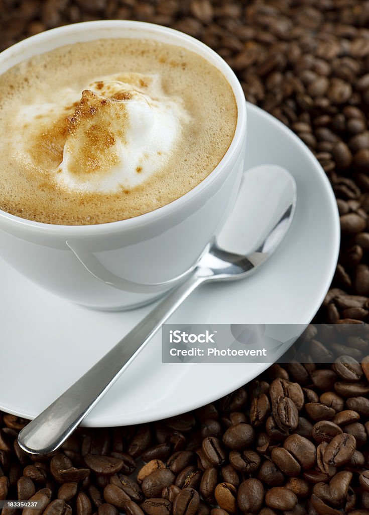 Cappuccino Cappuccino on coffee beans Caffeine Stock Photo