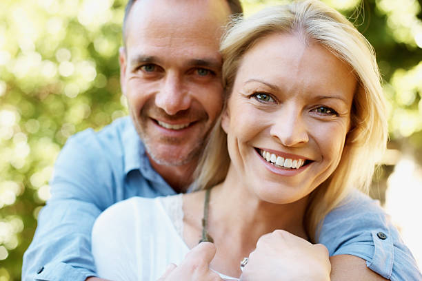 istock Happy middle-aged couple embracing and smiling 183354386